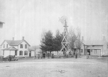 The original Bakkemellum log farm house is on the right. The building was covered with clapboard siding and it burned down in 1947. The farm house on the left remains almost unchanged from its construction in 1887. Photo courtesy of Walton Ofstedahl, 2000